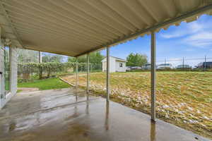 Fenced backyard featuring a patio and nice shed