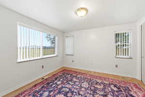 Primary bedroom featuring light wood L