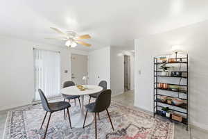 Dining area with ceiling fan and light tile patterned floors