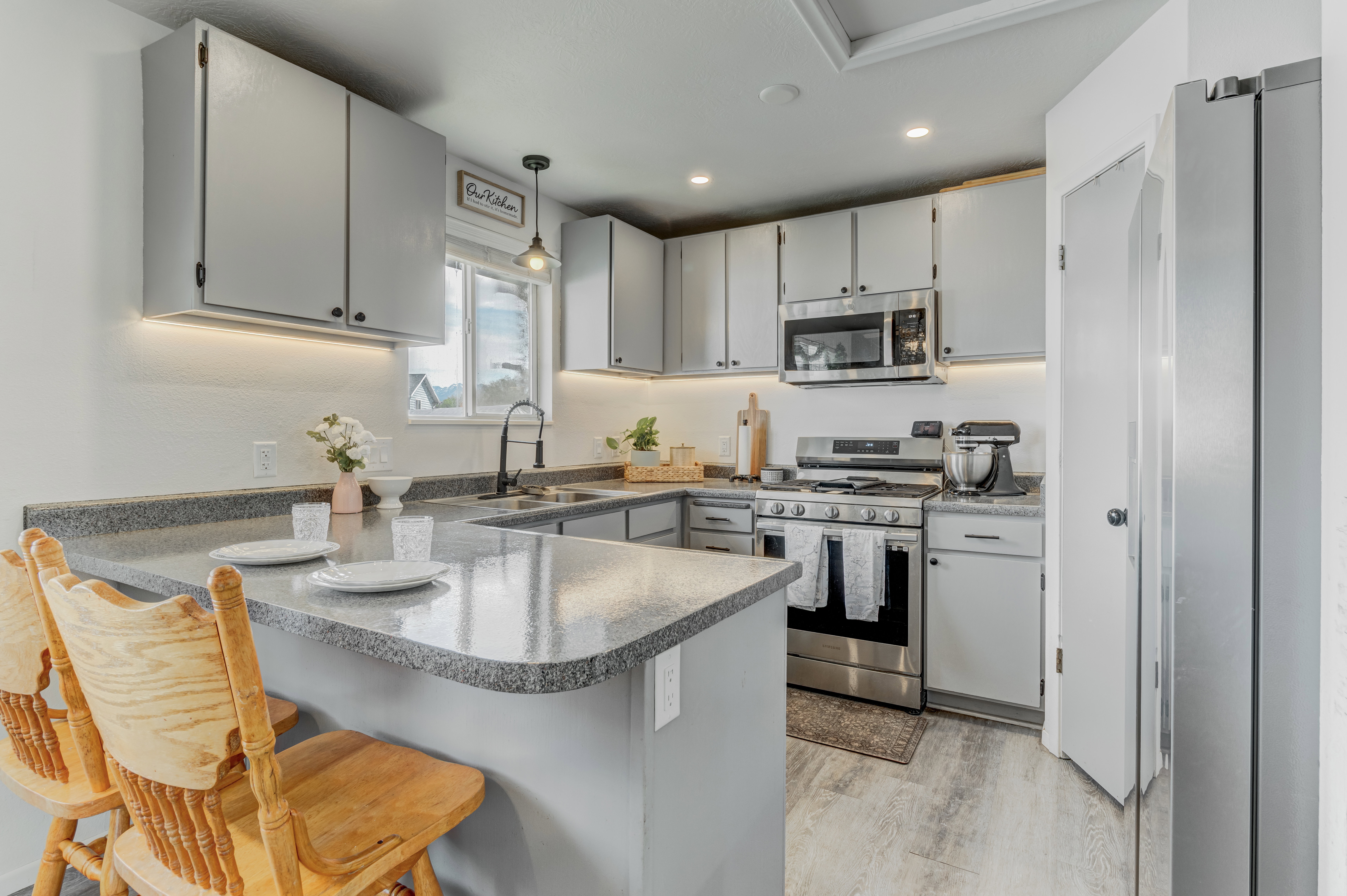 Kitchen with a breakfast bar area, stainless steel appliances,