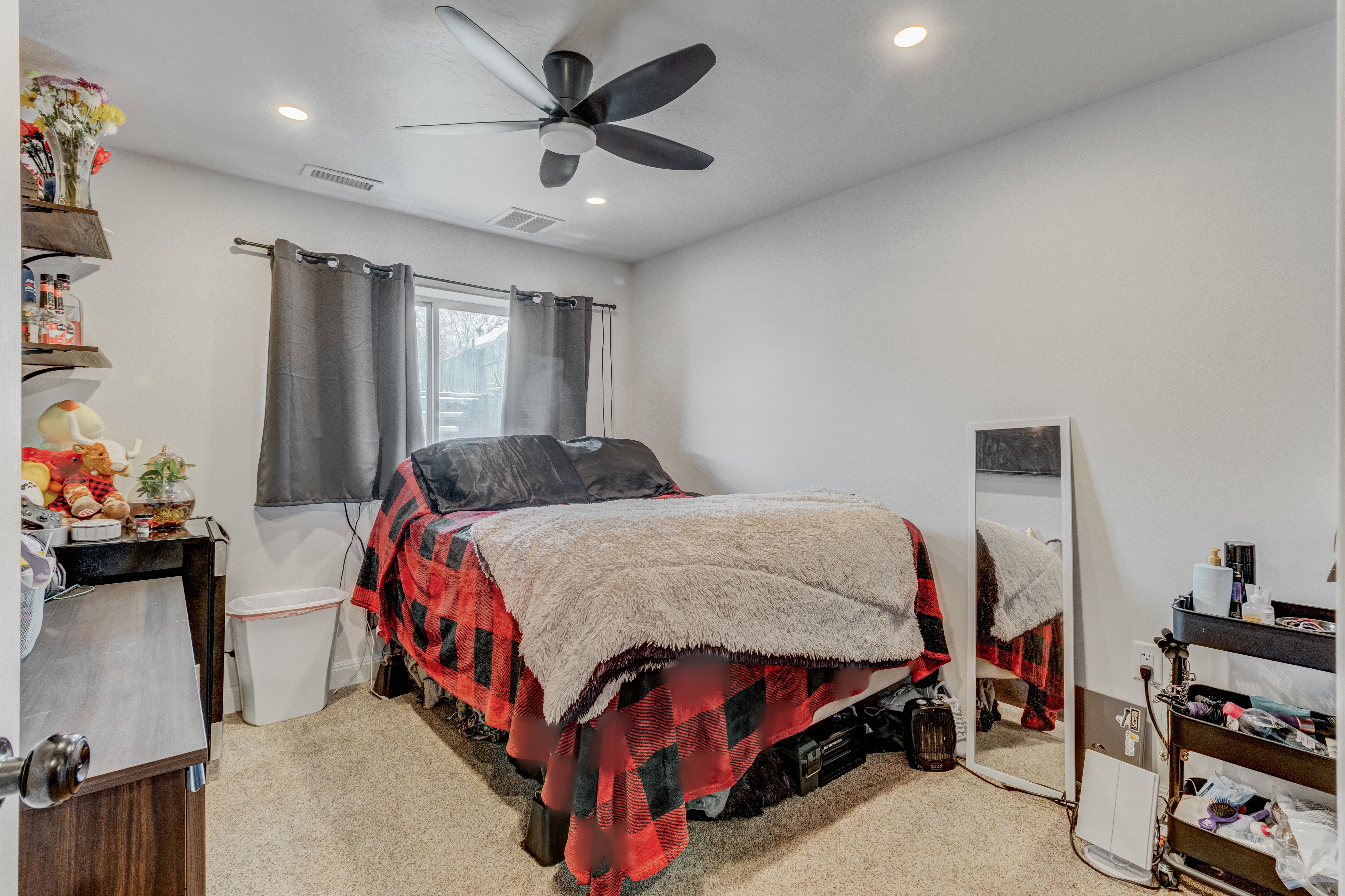 Bedroom with light colored carpet, recessed lighting, and a ceiling fan