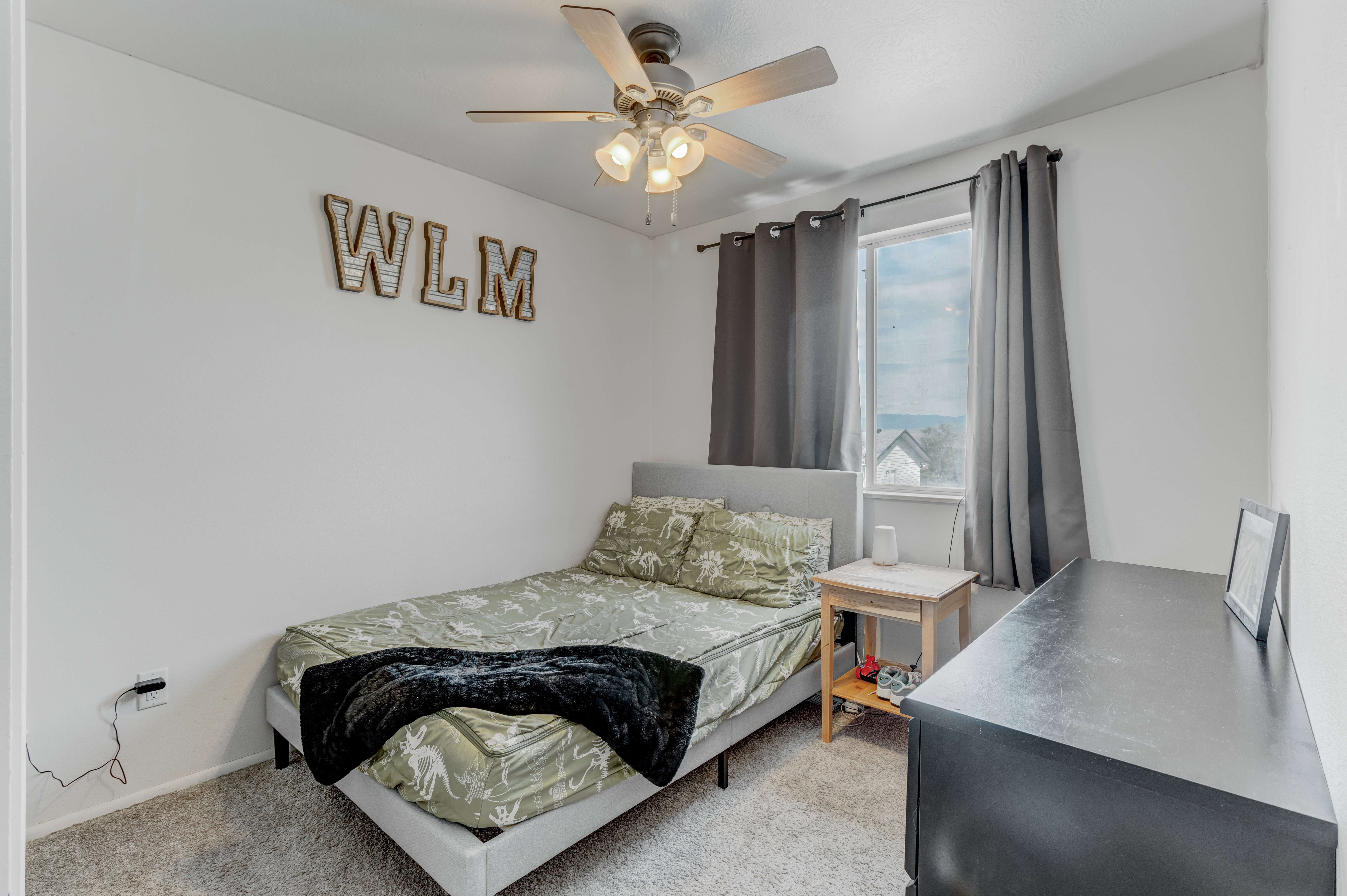 Bedroom with light carpet and ceiling fan