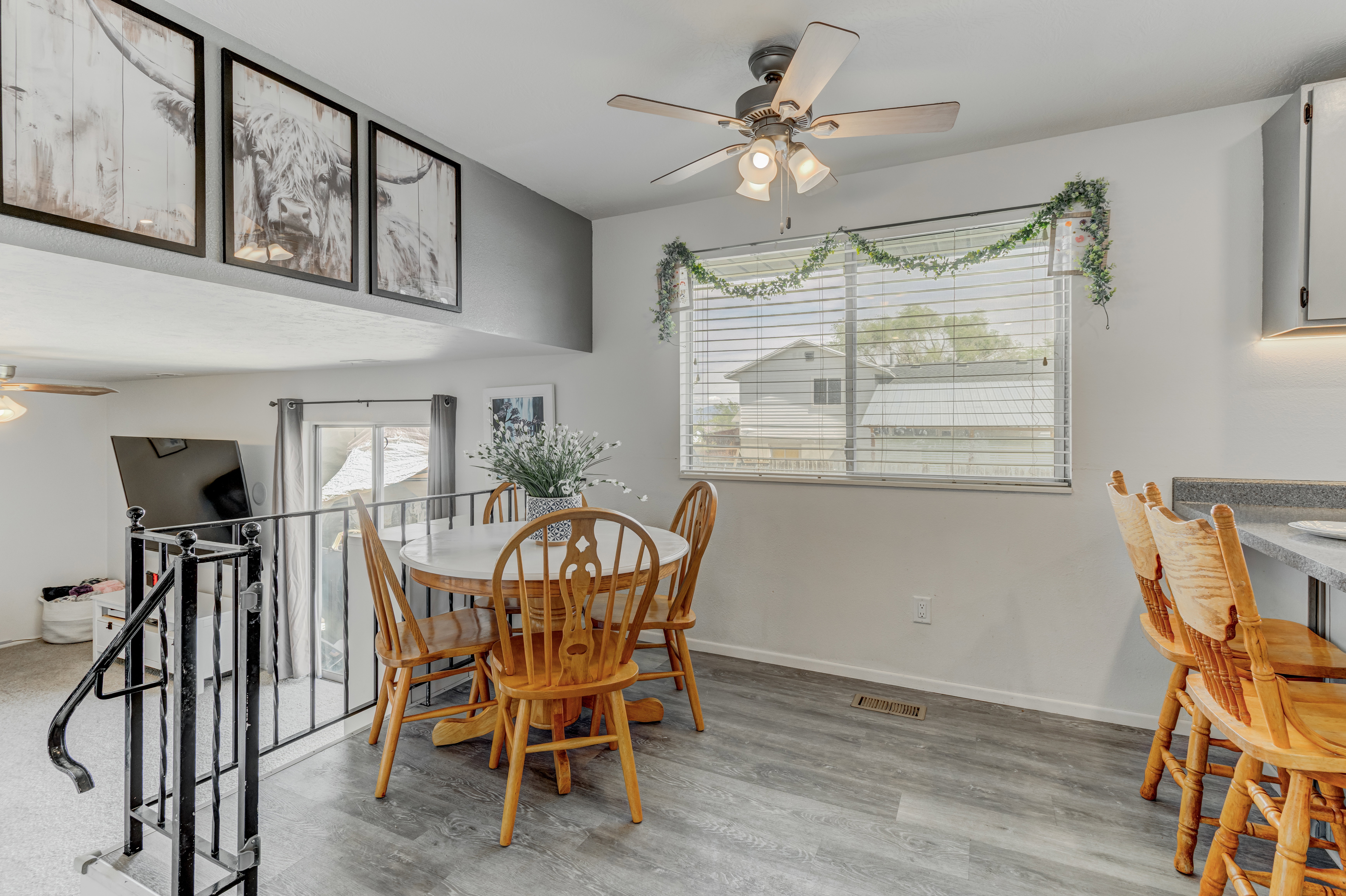 Dining space with a ceiling fan and light wood finished floors