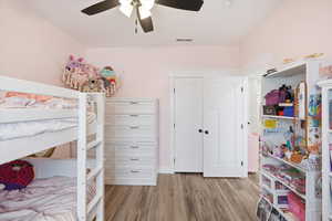 Bedroom with light wood-style flooring and ceiling fan