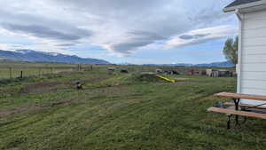 View of yard with a mountain view and a rural view