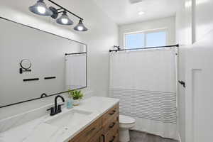 Bathroom featuring vanity and curtained shower