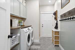Laundry room featuring cabinet space, independent washer and dryer, and recessed lighting