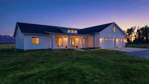 Modern farmhouse with covered porch, concrete driveway, and a garage