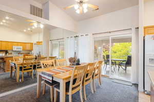 Dining area with views of the green space and pool.