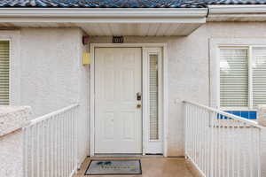 View of exterior entry featuring stucco siding