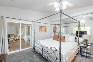 Bedroom featuring dark colored carpet, a ceiling fan, and access to Balcony