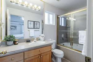 Ensuite bathroom with vanity and shower / bath combination with glass door, Soapstone countertops and throughout the bathroom