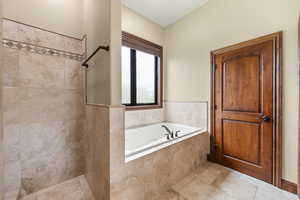 Bathroom featuring walk in shower and a garden tub