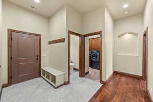 Mudroom with washer / clothes dryer, recessed lighting, and light wood-style flooring