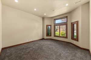 Carpeted spare room featuring recessed lighting