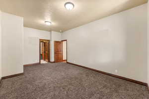 Unfurnished room with carpet flooring and baseboards