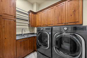 Laundry area with separate washer and dryer and cabinet space