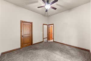 Unfurnished bedroom featuring carpet and ceiling fan