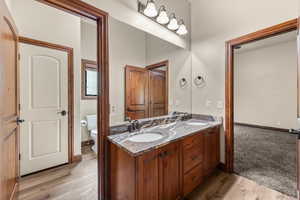 Full bathroom with double vanity and light wood finished floors