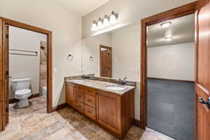 Bathroom featuring double vanity and light colored carpet