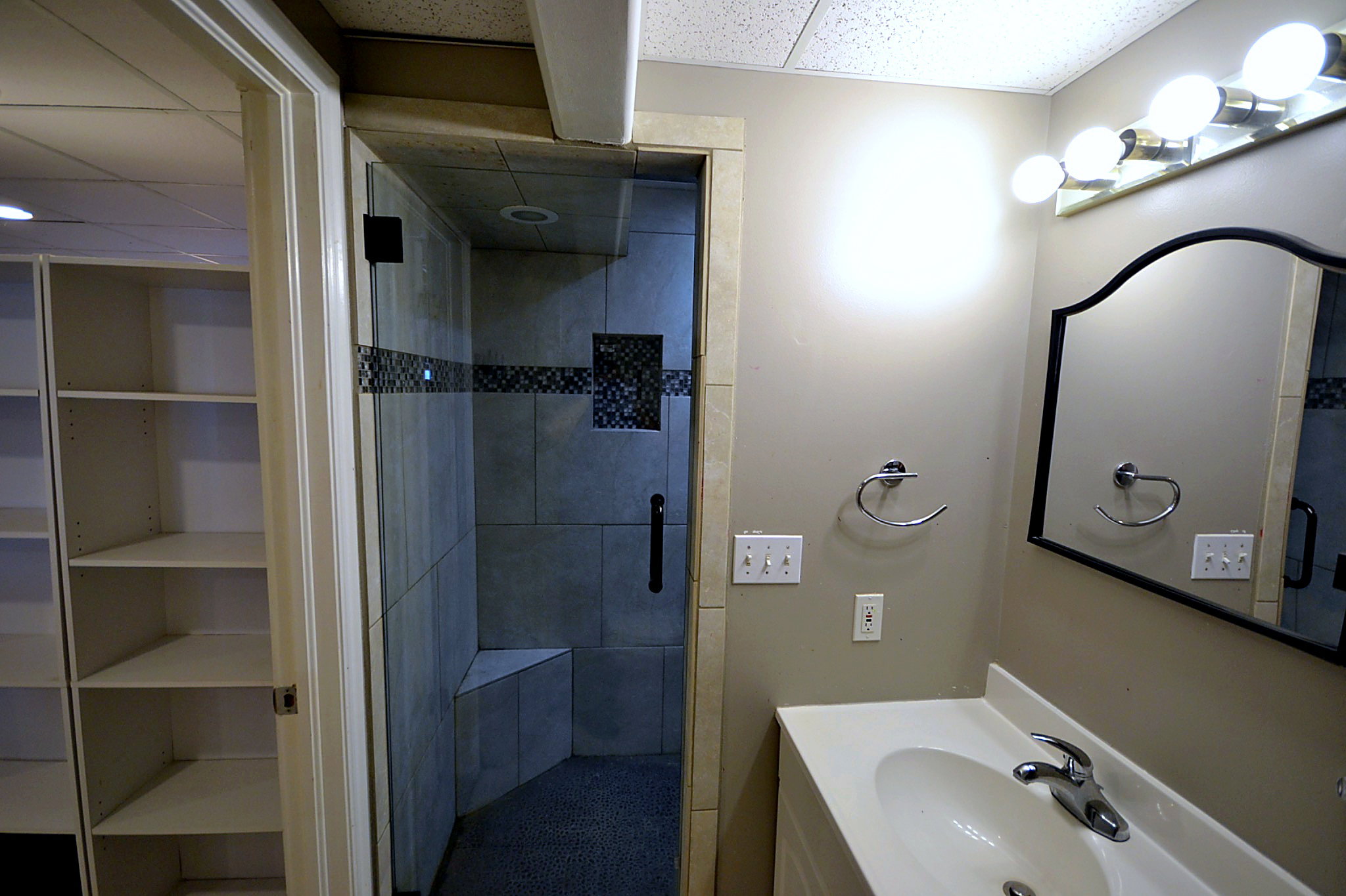 Full bath with a stall shower, vanity, and a drop ceiling