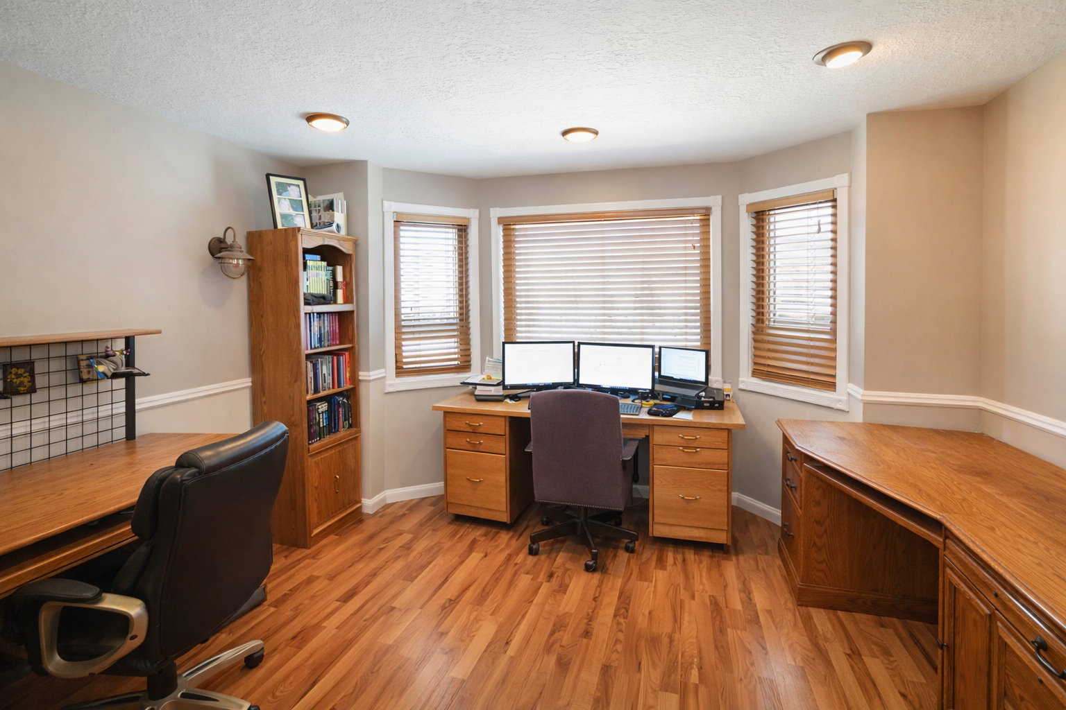 Office space with light wood-style flooring, a textured ceiling, and built in study area