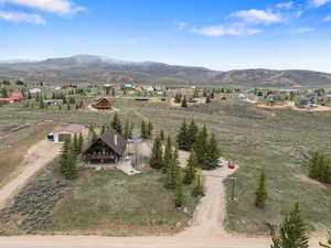 Aerial view of property and surrounding area with mountains