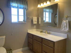 Half bathroom with vanity and light tile patterned floors