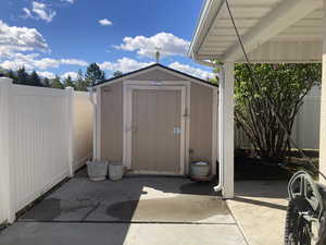View of shed with a fenced backyard