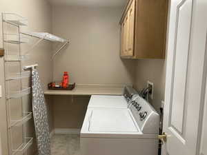 Laundry area featuring cabinet space and independent washer and dryer
