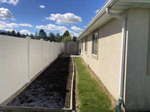 Fenced backyard with a storage unit