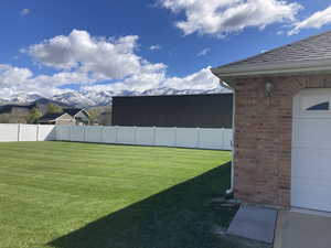 View of yard featuring a mountain view and a garage