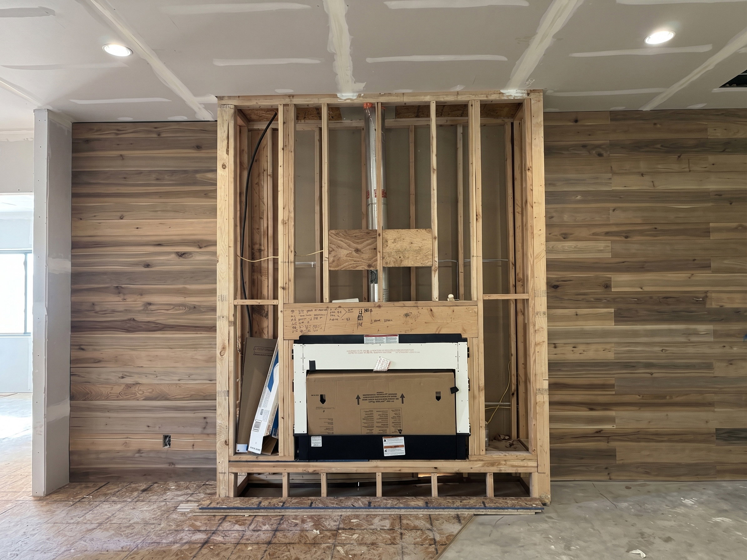 Custom fireplace framing with an integrated firebox, flanked by wood-finish accent walls