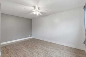 Spare room featuring light wood-style flooring and a ceiling fan