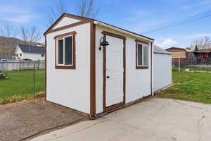 View of shed with a fenced backyard