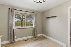Spare room with light wood-style flooring and baseboards