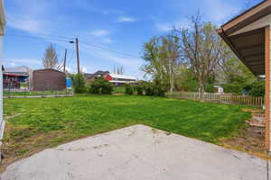 Fenced backyard featuring a patio