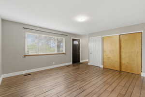 Foyer with light wood-type flooring and baseboards