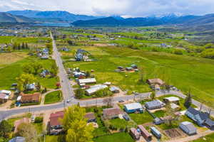 Aerial view of sparsely populated area featuring a mountain backdrop and a pastoral area