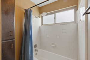 Bathroom featuring shower / tub combo with curtain