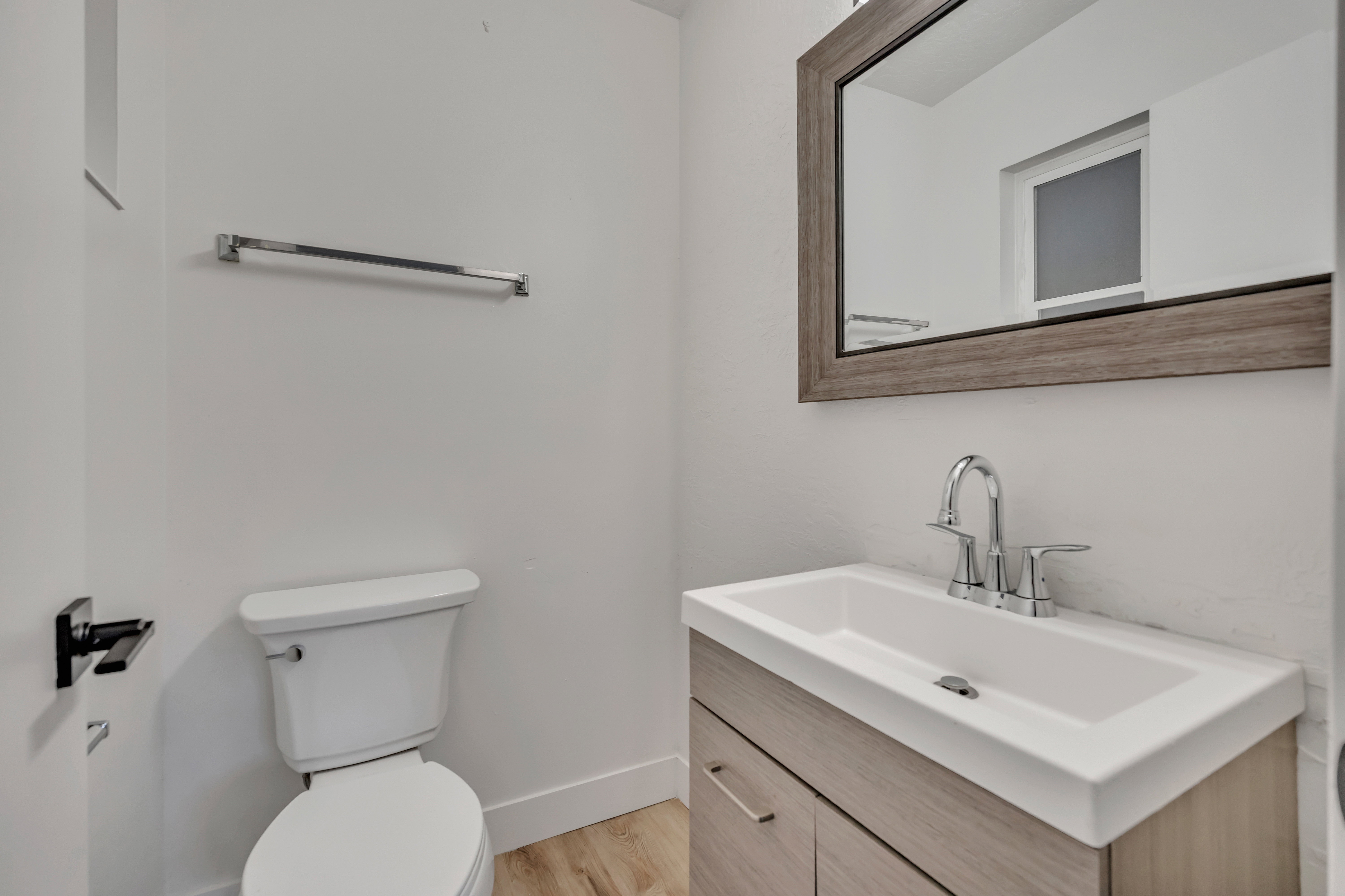 Half bathroom with vanity and light wood finished floors
