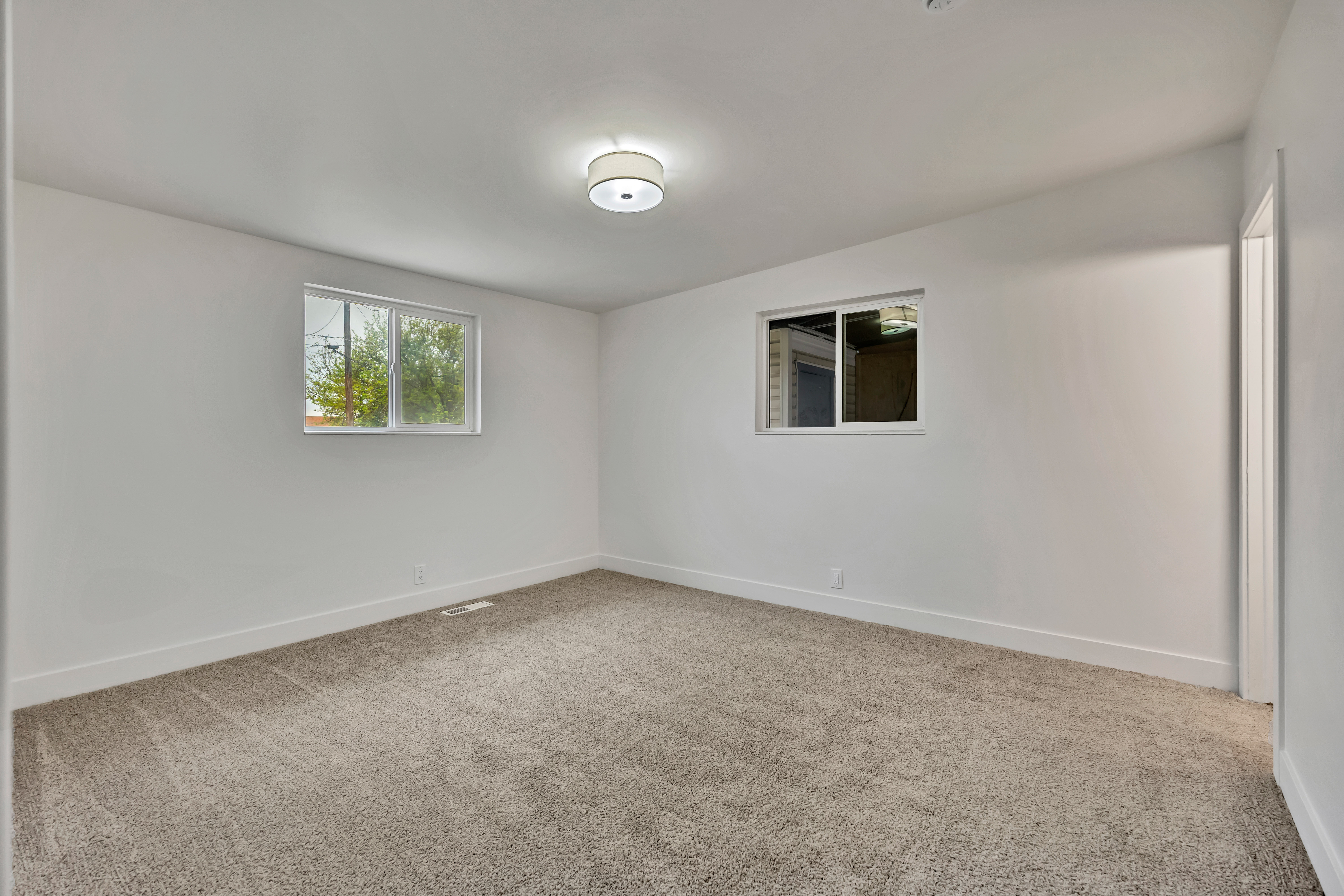 Unfurnished room featuring light colored carpet and baseboards