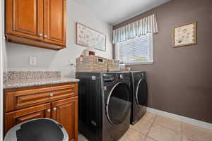 Laundry area featuring cabinet spaceWasher dryer hook ups