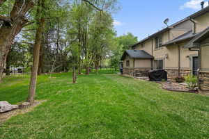 View of grassy yard with a patio