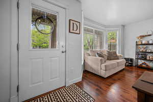 Entrance foyer featuring wood-style floors and baseboards