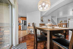 Dining area featuring suspended lighting and  wood-style floors