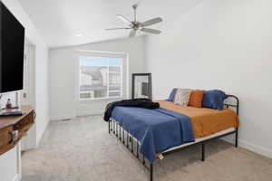 Bedroom with vaulted ceiling, a ceiling fan, light carpet, and recessed lighting