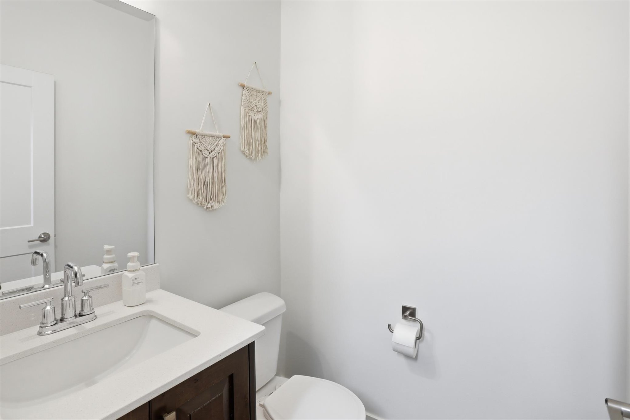Half bathroom featuring vanity and toilet