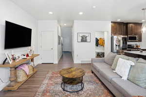 Living room with dark wood-style floors and recessed lighting