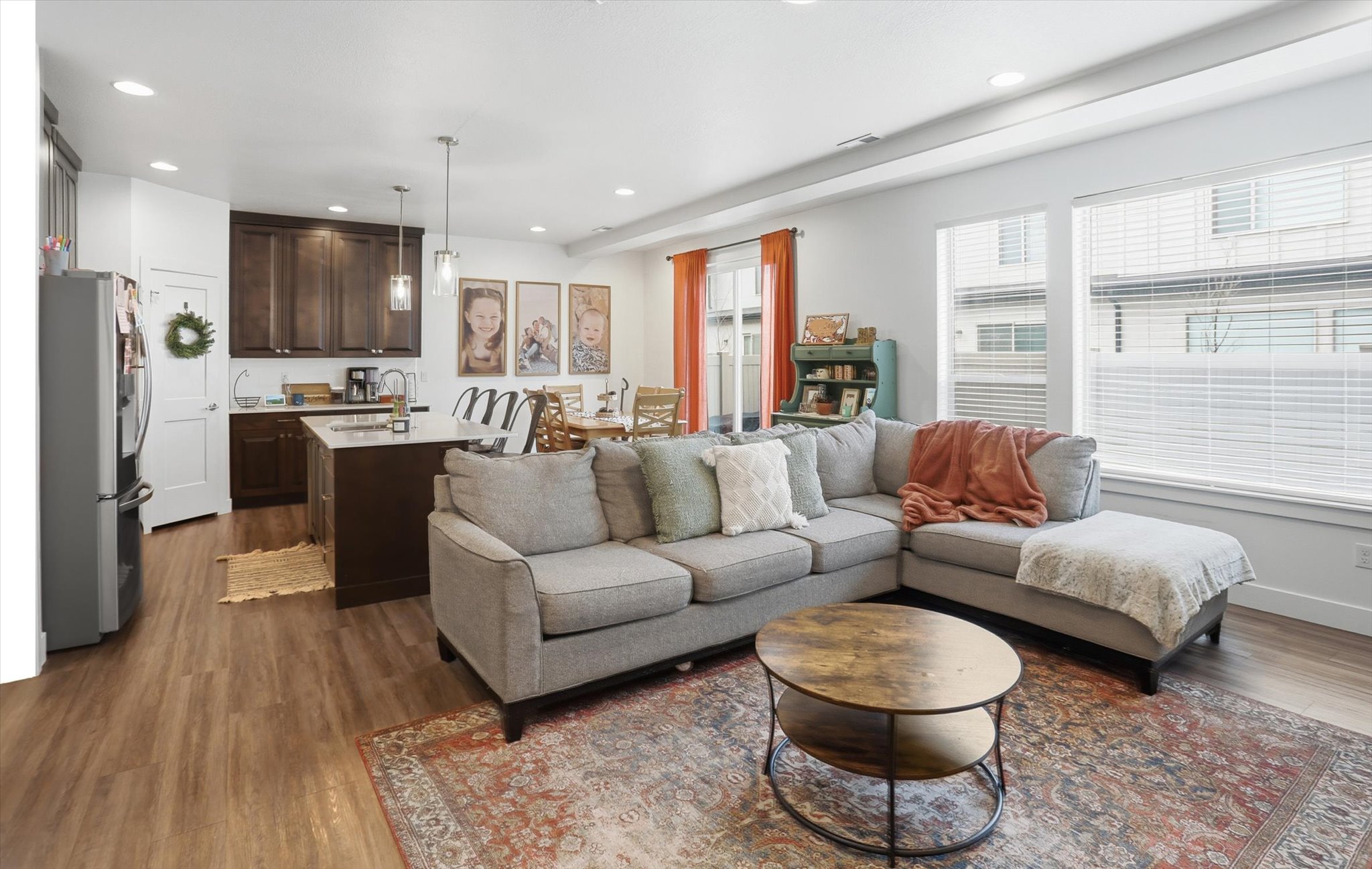 Living area with dark wood finished floors and recessed lighting